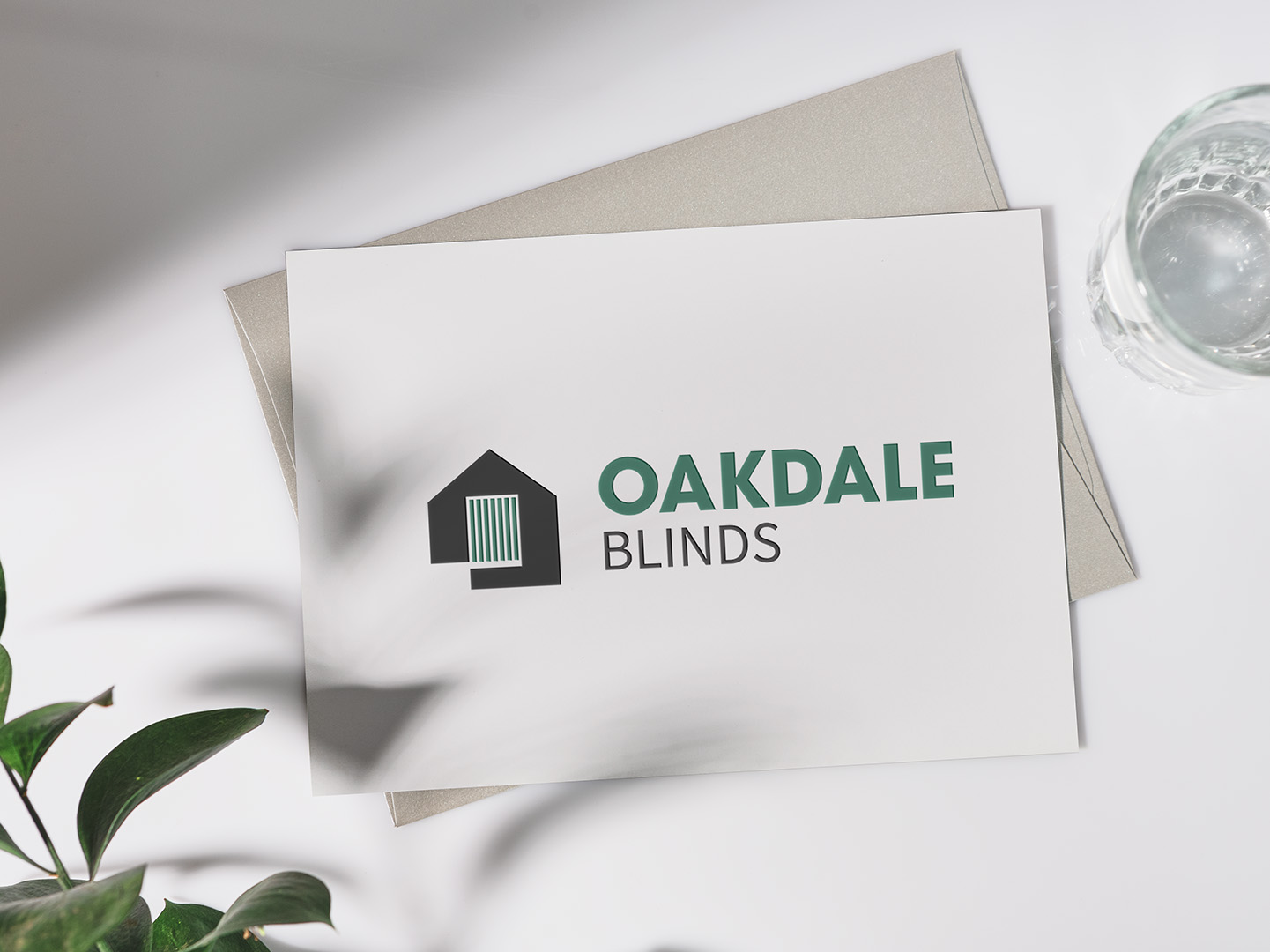 abstract house with blinds logo on a business card for oakdale blinds